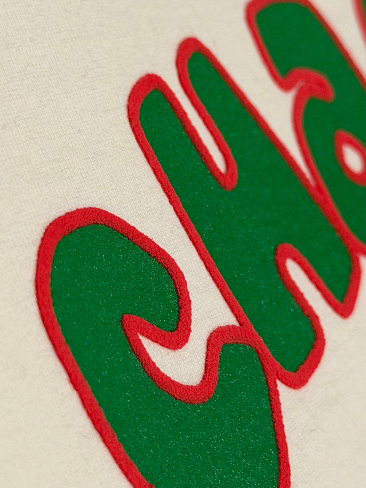 Charlie Appleseed off-white heavyweight cotton t-shirt with green and red raised puff-print logo detail