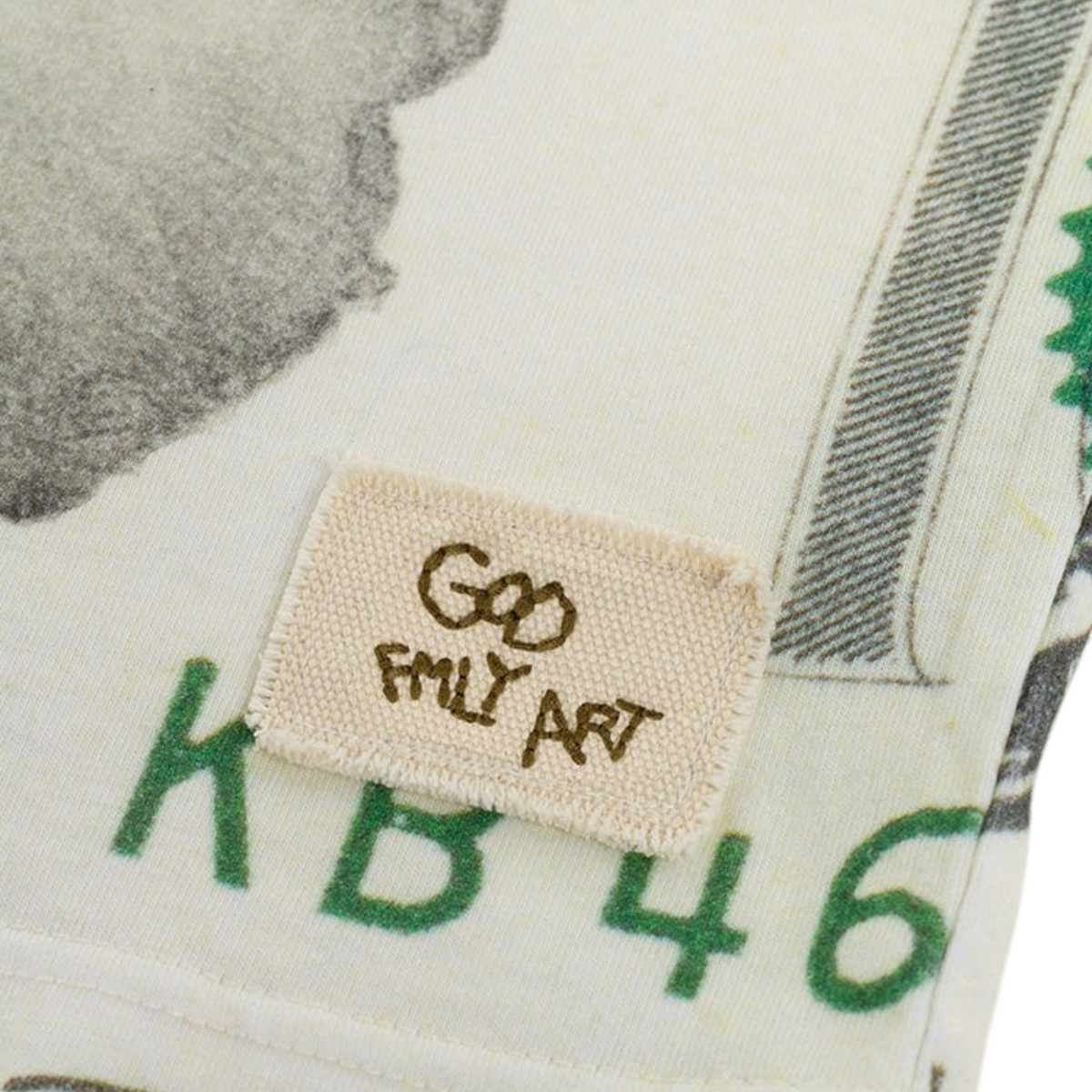 Charlie Appleseed Banker Knit by GOD FAMILY ART featuring a cream fabric with green currency-inspired print and label